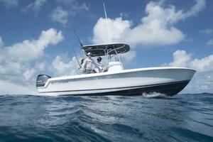 2023 Contender 24 Sport boat navigating ocean waves under a 