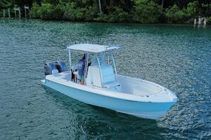 2023 Contender 24 Sport boat on calm water, featuring dual e