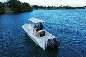 2023 Contender 24 Sport boat on blue water with dual Yamaha 