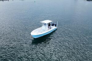 2023 Contender 24 Sport boat cruising on calm waters.