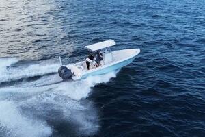2023 Contender 24 Sport boat cruising on open water, creatin