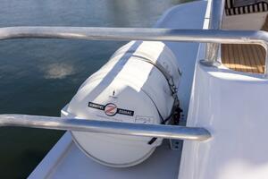 Liferaft on 1996 ABD 90 Explorer yacht deck, near water.