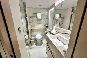 Luxurious marble bathroom in 2023 Majesty 120 yacht, featuring modern fixtures and elegant design.