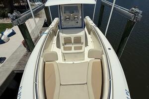 2015 Cobia 296 Center Console boat docked, featuring spaciou