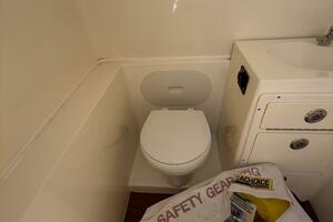 2015 Cobia 296 Center Console boat bathroom with toilet and 