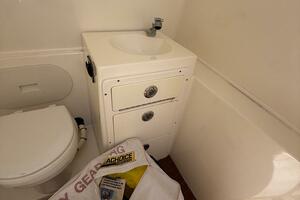 2015 Cobia 296 Center Console boat bathroom with sink and st
