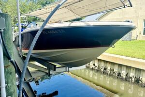2013 Chris-Craft Corsair 22 boat on lift, docked near water.