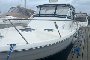 2001 Pursuit 3000 Offshore boat docked at marina, featuring 