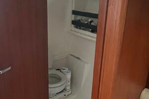 2001 Pursuit 3000 Offshore boat bathroom with wooden door an