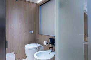 Modern bathroom with toilet and bidet on Majesty 140 yacht, 