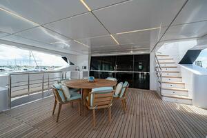 Spacious deck of 2020 Majesty 140 yacht with wooden furnitur