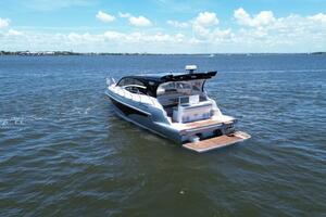 Luxury yacht Real 40 HT 2025 cruising on open water under a clear blue sky.