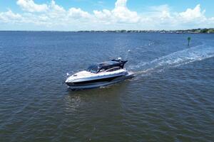 Luxury yacht Real 40 HT cruising on open water under a clear blue sky.