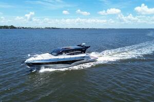 Luxury yacht Real 40 HT cruising on open water under a clear blue sky.