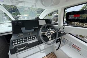 2025 Real 40 HT Luxury yacht cockpit with modern steering and navigation controls.