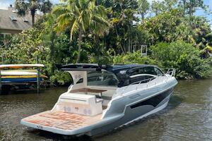 Luxury yacht Real 40 HT 2025 cruising on a scenic river with lush greenery.