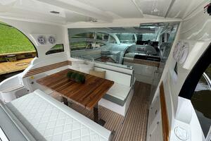 2025 Real 40 HT Luxury yacht interior with elegant seating and wooden table.