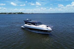 Luxury yacht Real 40 HT 2025 cruising on open water under a clear blue sky.