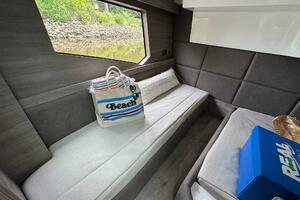 Interior of 2025 Real 40 HT Luxury yacht with beach bag and window view.