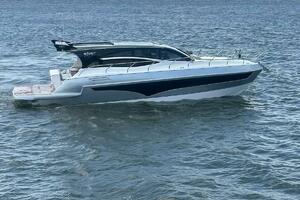2025 Real 40 HT Luxury yacht cruising on a calm sea under a cloudy sky.