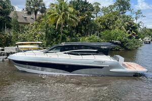 2025 Real 40 HT Luxury yacht on a river, surrounded by lush greenery and palm trees.