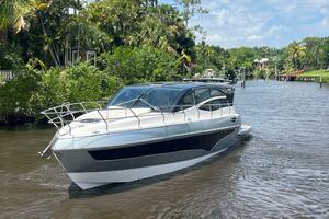 2025 Real 40 HT Luxury yacht cruising on a scenic river.
