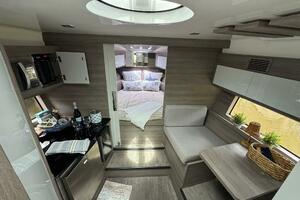 Luxurious interior of 2025 Real 40 HT yacht, featuring modern kitchen and cozy bedroom.