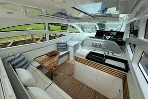 Luxurious interior of 2025 Real 40 HT yacht with elegant seating and modern helm.