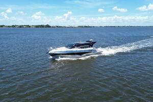 Luxury yacht Real 40 HT cruising on open water under a clear blue sky.