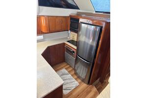 2004 Carver 466 Motor Yacht kitchen with wood cabinetry and 