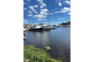 2004 Carver 466 Motor Yacht docked in a sunny marina with bl