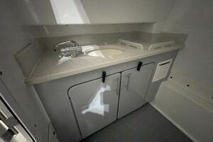 Boat Head Sink and Cabinetry Inside Center Console Compartme