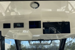 2023 Boston Whaler 350 Realm dashboard with electronic controls and storage compartments.